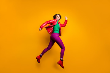 Fototapeta na wymiar Full size profile photo of funny lady jumping high rushing shopping discount prices wear casual red overcoat trousers turtleneck boots isolated yellow color background