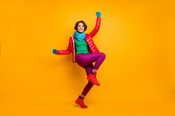 Fototapeta na wymiar Full size profile photo of funky lady raise hands leg crazy millennial person wear casual red coat blue scarf gloves turtleneck trousers footwear isolated yellow color background