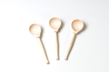 three wooden spoons on a white background, top view of the design blank