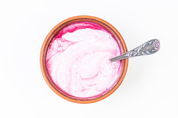 fresh homemade yogurt in a clay plate on a white background
