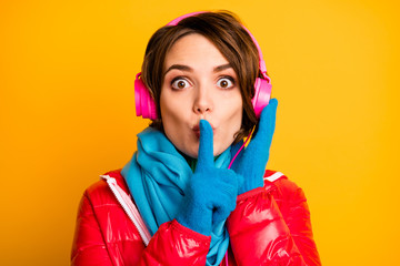 Don't speak. Closeup photo of beautiful lady listen modern earphones hold finger on lips wear...