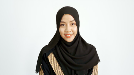Close Up Portrait of a Young Asian Muslim Woman dressing in the traditional Hijab looking at camera...