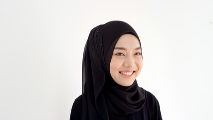 Close Up Portrait of a Young Asian Muslim Woman dressing in the traditional Hijab looking at camera...