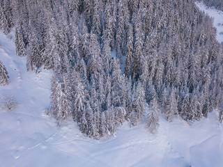 Aerial view of snow covered winter landscape in rural mountain region.