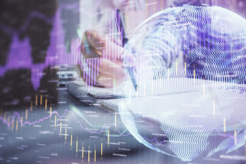 Financial forex graph drawn over hands taking notes background. Concept of research. Double exposure