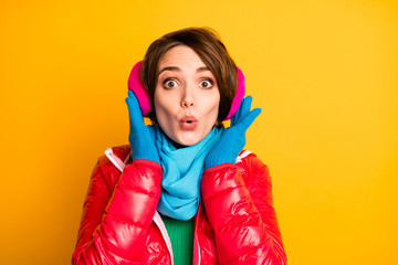 Closeup photo of funny lady nice ear warmers open mouth shocked wear stylish casual red overcoat blue scarf gloves pink earmuffs isolated yellow color background