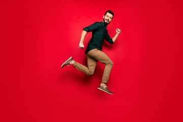 Full length profile side photo of positive cheerful guy jump run after black friday sales wear...