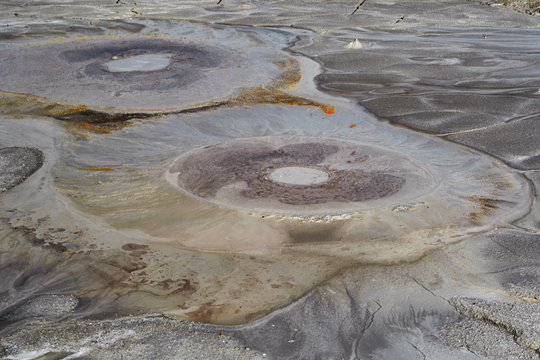Bubbles of mud exiting from earth from a mud volcano in Berca, Romania.