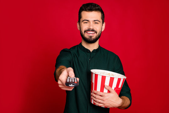 Portrait Of Cheerful Guy Have Free Time Watch Tv Switch Remote Control Hold Big Popcorn Box Enjoy Emotion Wear Good Looking Outfit Isolated Over Shine Color Background