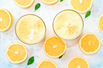 orange juice in a glass, top view, slices of oranges, straw, healthy lifestyle concept
