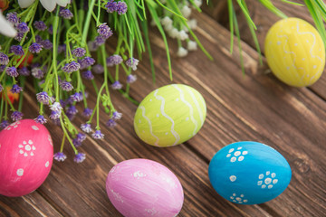 Obraz na płótnie Canvas Colorful pastel easter eggs on wooden board background