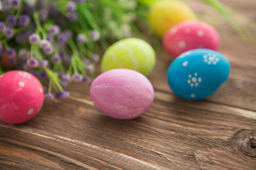 Fototapeta na wymiar Easter eggs on wooden background. Colorful pastel easter eggs on wooden board background