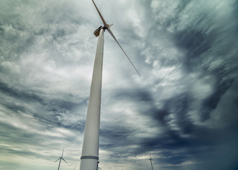 Wind generators against the backdrop of a dramatic stormy sky. Alternative energy sources.