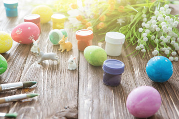 Rabbits with easter eggs on wooden table. Cute Little easter bunny.