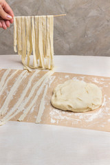 Rolled dough, sliced into strips. Process of making homemade pasta