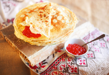 Homemade hot pancakes with caviar. Rustic style, crepes close-up.