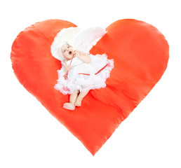 Happy Valentines Day and Love. Angel baby from heaven yawns at the big red heart. Cupid in white wings with bow and arrows in studio at white background, isolated.