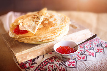Homemade hot pancakes with caviar. Rustic style, crepes close-up.