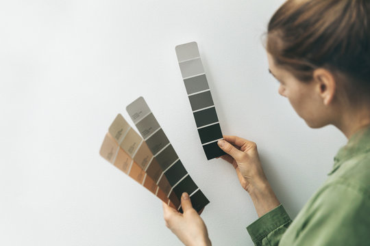 Interior Designer Selecting Wall Paint Color From Samples