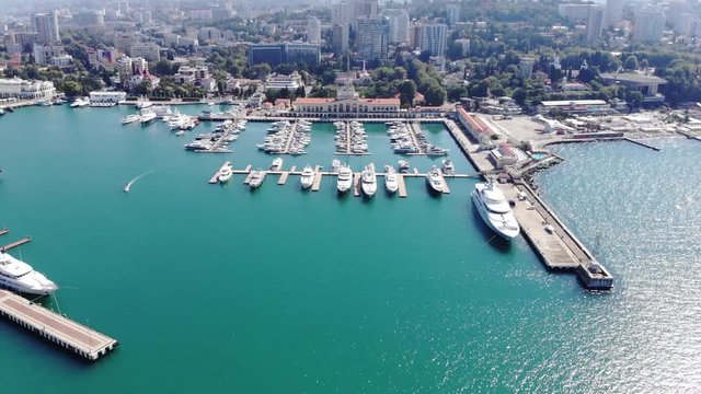 Aerial Footage, beautiful cityscape Sochi Russia, famous resort, maritime center, city promenade, beaches azure sea, hotels, modern yachts piers, summer journey, freedom, horizon, clouds, Black sea