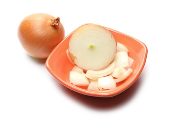 Onion bulb cut in half and chopped slices in bowl, isolated on white background