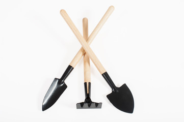 Various small gardening tools close-up on a white background, top view