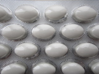 pack with vitamins in the form of oval white tablets