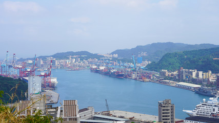 View of the passenger and cargo port in Taiwan. Panorama of the Asian port city. blue water of the pacific ocean in the bay of keelung. green hilly island