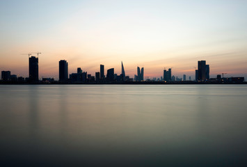 Fototapeta na wymiar Bahrain skyline and dramatic hue at sunset, Bahrain