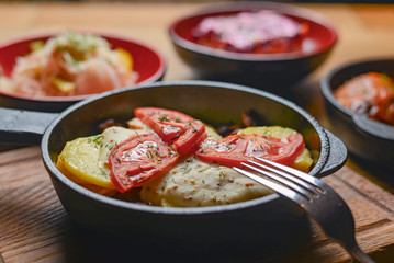 Table with traditional Ukrainian food, boiled buckwheat with meat gravy, meat and mushroom gratin, lazy cabbage rolls.