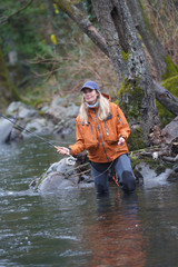 woman fly fishing in river