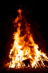 Large bonfire in the night. Fire flames on black background.
