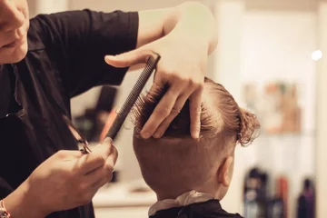 Draagtas Close-up of kid getting a haircut at the salon. © LumineImages