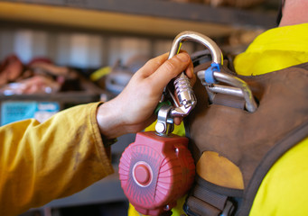 Close up construction hand clipping locking carabiner which connecting into self retractable shock...