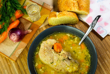 The pea soup with pork in a plate on the table close-up