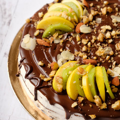 Homemade delicious sweet cake with fruits, chocolate, apple, kiwi on cup of coffee americano, white background. Organic dessert sugarless. Healthy eating.