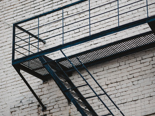 Facade with fire rescue steel ladder of old house in Moscow, Russia. Fire escape from steel...