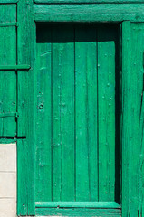Old weathered green rural house wooden door closeup