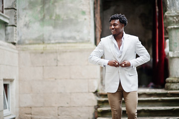 Thoughtful young handsome african american gentleman in formalwear. Black stylish model man in white jacket.