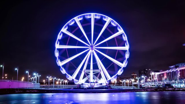 Time lapse ferris wheel at the amusement park at night.