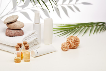 Spa still life with creams, essential oils, towels on light background. Healthy lifestyle, body care, Spa treatment