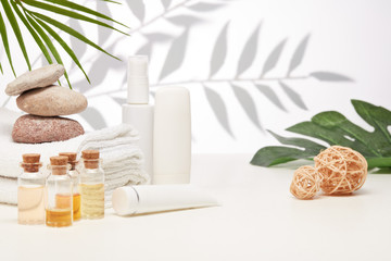 Spa still life with creams, essential oils, towels on light background. Healthy lifestyle, body care, Spa treatment