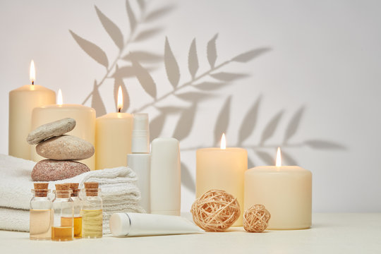 Spa still life with creams, essential oils, candles on light background. Healthy lifestyle, body care, Spa treatment