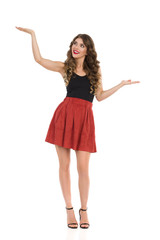 Beautiful Young Woman In Mini Skirt And High Heels Is Holding Hands Raised And Comparing Something