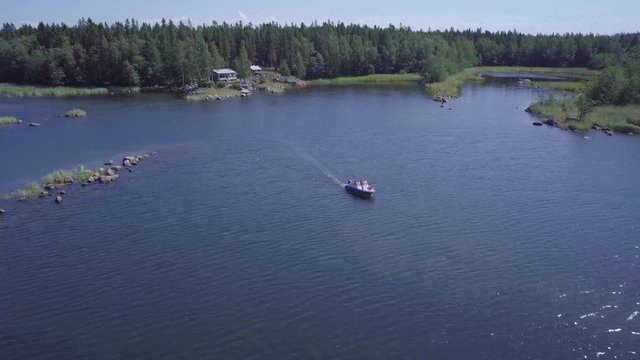 Boating family cruising through summer archipelago in Finland, aerial