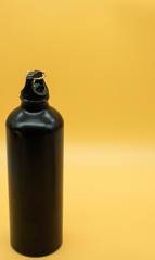 View of an eco friendly reusable aluminum thermo bottle. Yellow background. Zero waste concept.