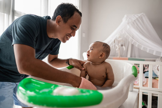 Happy Asian Father Taking Bath Of His Baby Toddler