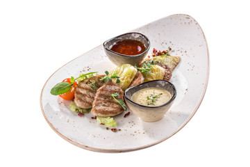 Grilled meat with baked pepper and tomato sauce on white plate isolated on white background