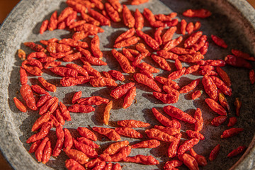 Dried small red chilies in a stone bowl