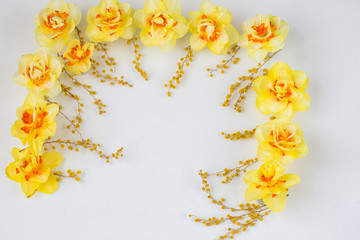 the arch is lined with daffodils and mimosa